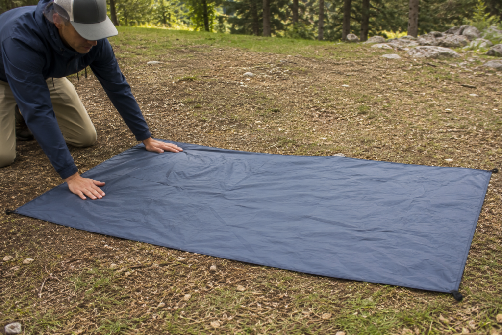 how to pitch a tent laying out tent groundsheet footprint on campsite before tent body protecting floor from moisture
