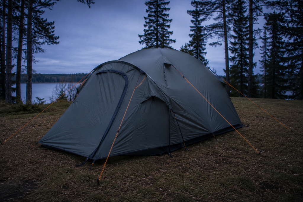 how to pitch a tent guylines attached and tensioned from rainfly to ground stakes showing proper guyline technique outdoor