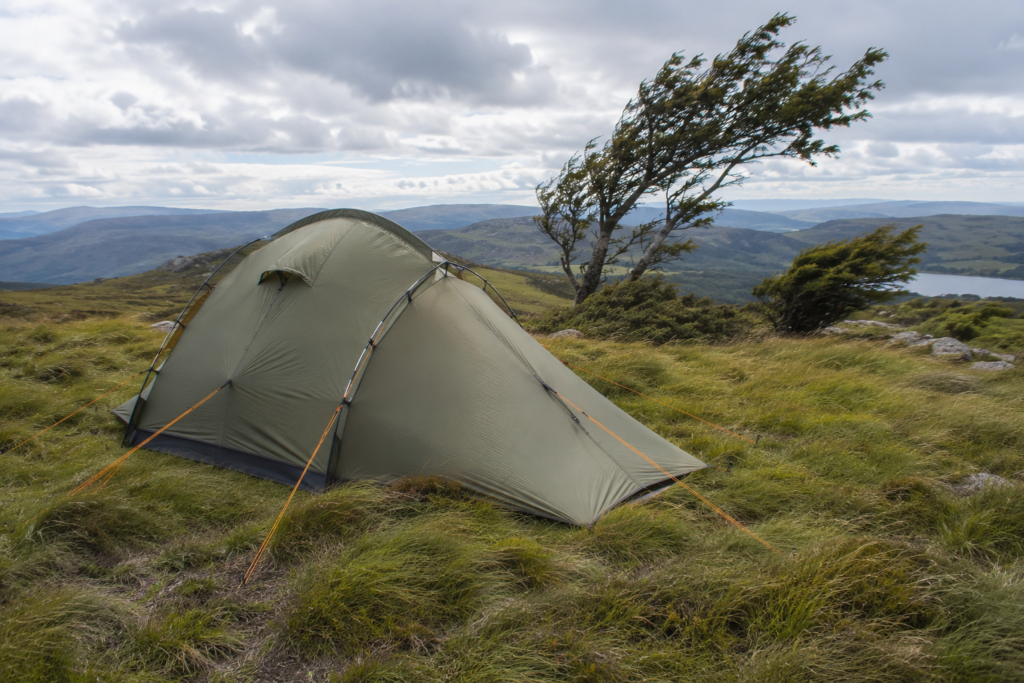how to pitch a tent in wind strongest pole side facing into wind for stability campsite exposed terrain