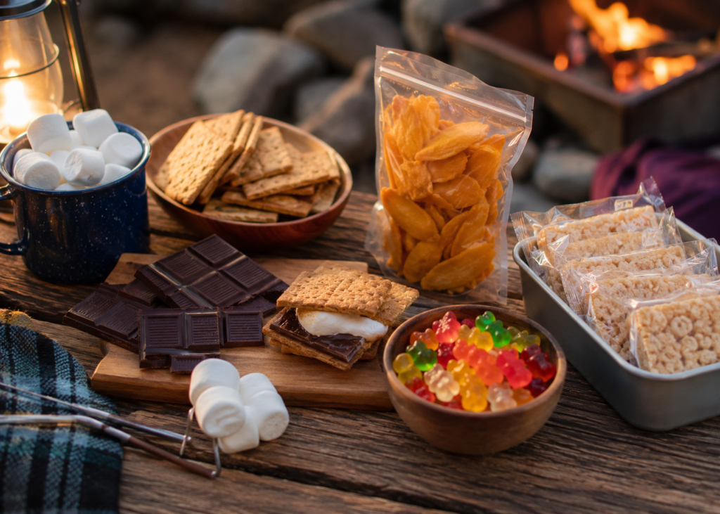 ready to eat camping food desserts smores ingredients marshmallows graham crackers chocolate and dried fruit on camp table