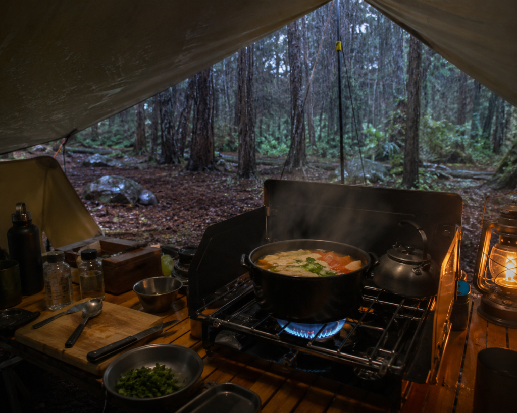 wet weather camping cooking under tarp canopy portable stove one pot meal rain campsite dry cooking area
