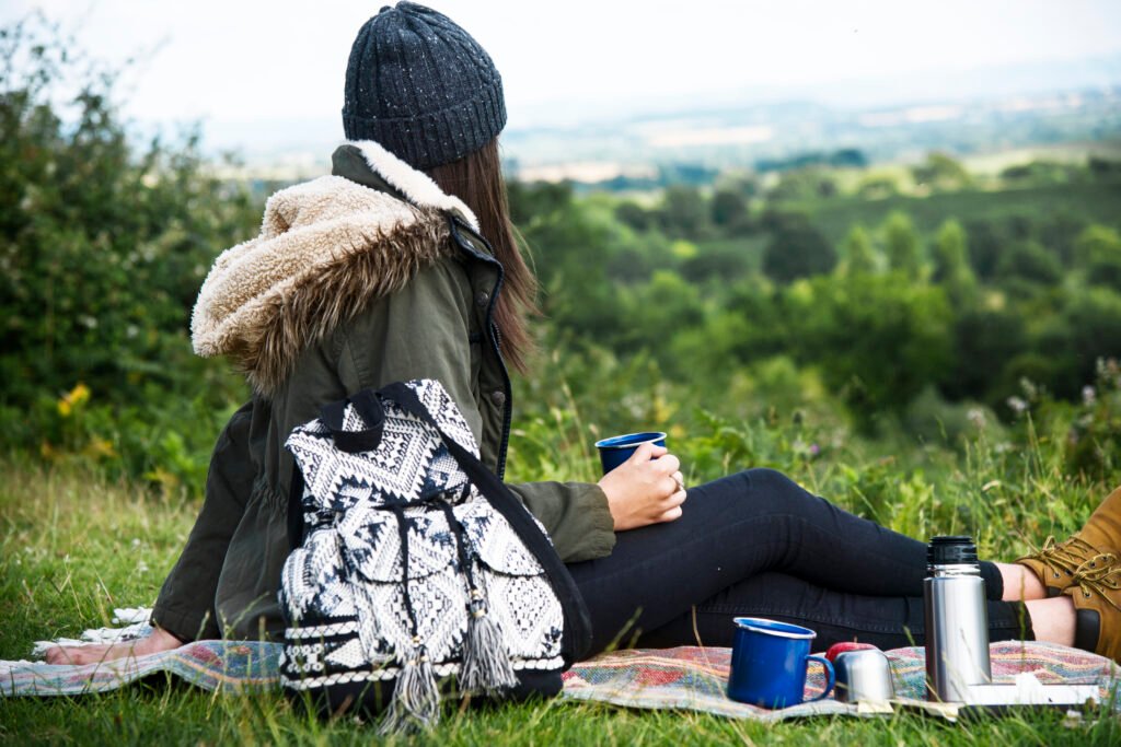 A solo female camper enjoying scenic beauty near her campsite