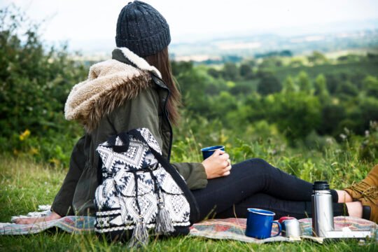 A solo female camper enjoying scenic beauty near her campsite