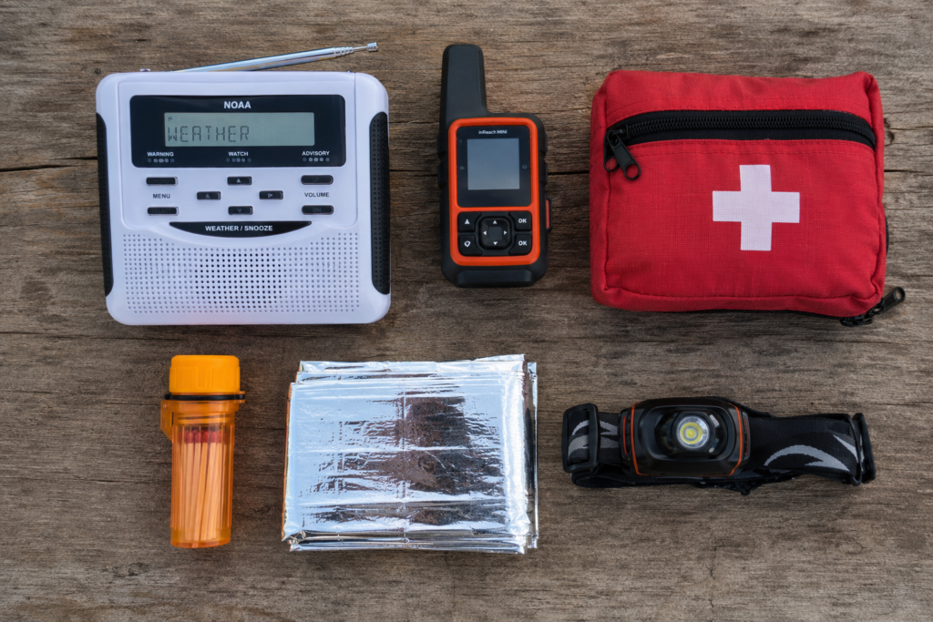 lightning safety while camping essential gear NOAA weather radio satellite communicator first aid kit emergency supplies