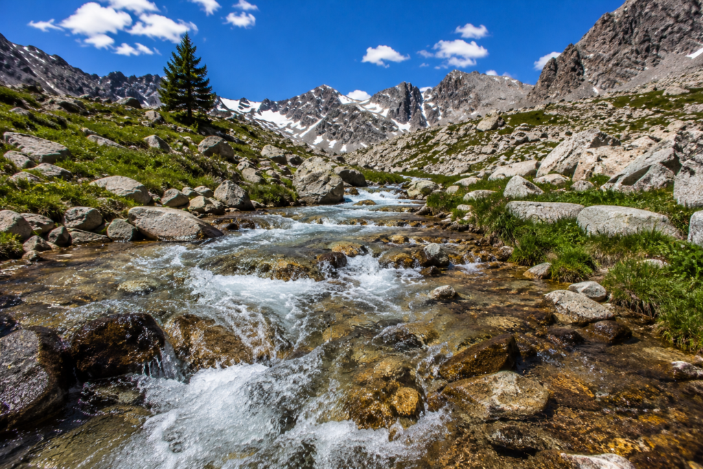 purifying water in the wilderness finding clean water source mountain stream flowing water above treeline