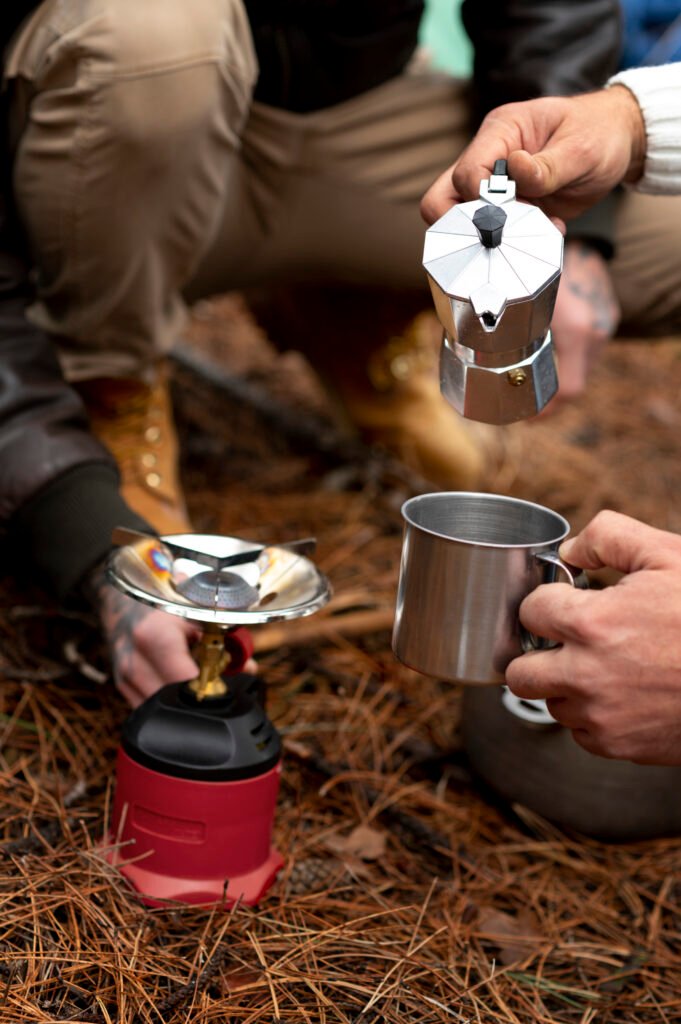 Compact camping stove with fuel canister on outdoor surface - best lightweight backpacking stoves 2025